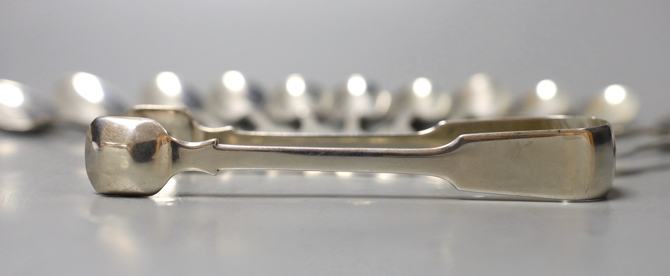 A set of six George IV silver fiddle pattern teaspoons, Eley & Fearn, London, 1820, a set of six William IV silver fiddle pattern teaspoons, J & A. Savory, London, 1836 and a pair of sugar tongs, London, 1827, 10.9oz.